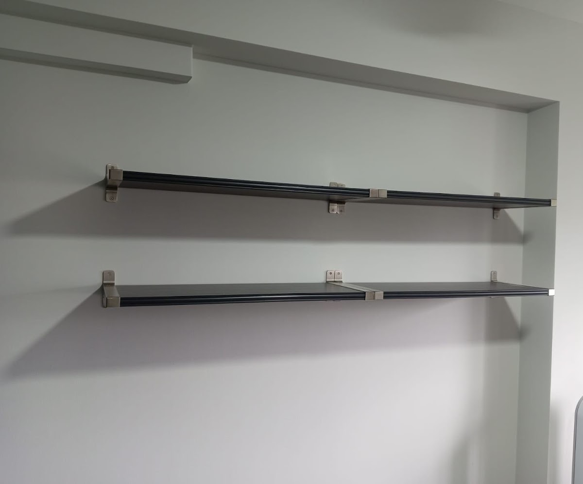 Two long wall shelves freshly mounted on brackets