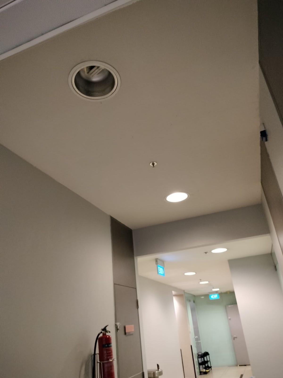 Commercial corridor with recessed downlights after repair work