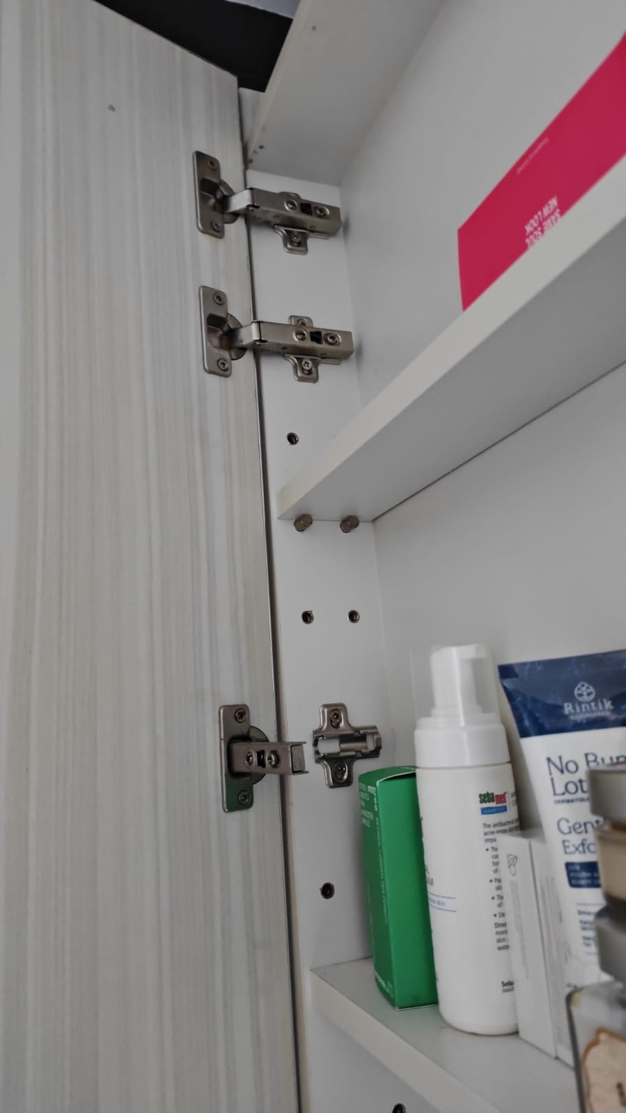 Soft close cabinet hinges replaced inside a bathroom cabinet
